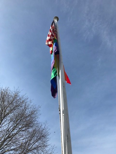 flag pole with American flag and Pride flag