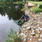 Student collects water from a pond