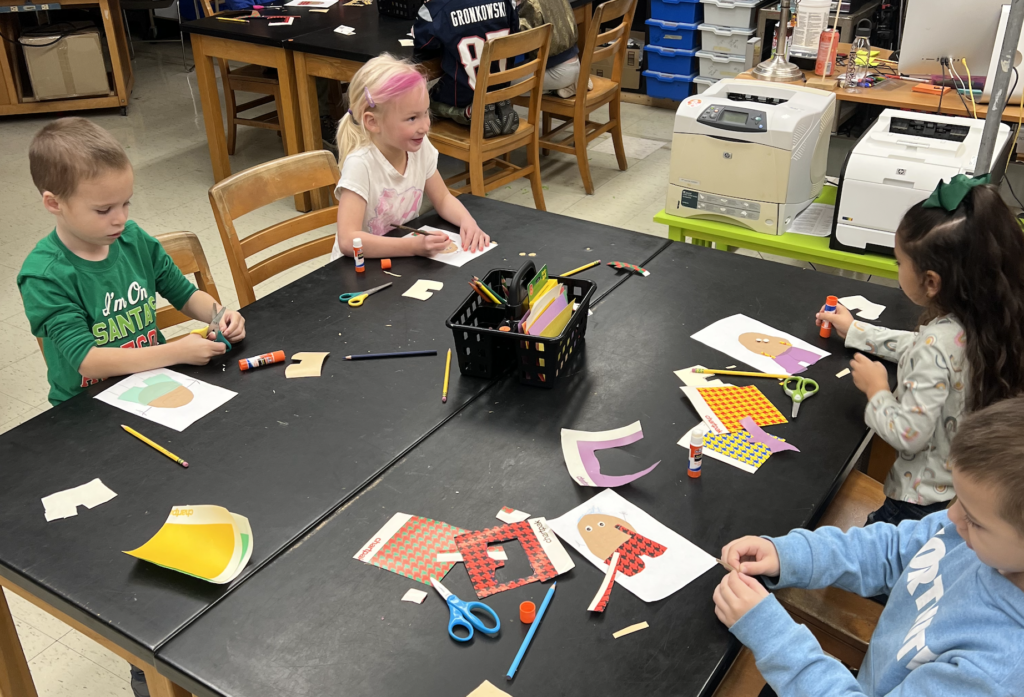 students working on cutting out different colored paper and gluing it to a paper potato